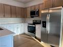 Bright kitchen featuring stainless steel appliances, light countertops and wood cabinets at 1905 Harvard St, North Las Vegas, NV 89030