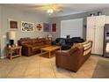 Comfortable living room with tile flooring, a ceiling fan, and ample seating for Gathering and guests at 2267 Muir Ct, Henderson, NV 89052