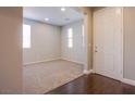 Inviting entryway with carpeted area and wood floors at 2369 Via Barranca St, Henderson, NV 89044