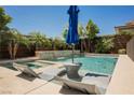 Inviting backyard pool and spa surrounded by lush landscaping offers a private oasis for relaxation and entertainment at 2750 Evolutionary Ln, Las Vegas, NV 89138