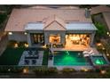 Aerial view of backyard with a sparkling pool, spa, outdoor kitchen, and inviting patio area for entertainment at 2820 High Range Dr, Las Vegas, NV 89134