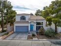Two-story home with xeriscaping, tile roof, and an attached two-car garage is shown on a sunny day at 3481 Creek River Dr, Las Vegas, NV 89129