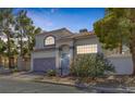 Charming two-story home with a tile roof and a well-manicured, xeriscaped front yard at 3481 Creek River Dr, Las Vegas, NV 89129