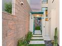 Modern entryway with decorative wall, manicured plants and stone pavers and a secure privacy wall at 358 Solitude Peak Ln, Henderson, NV 89012
