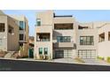 Modern, multi-level home featuring spacious garages, balconies, and desert landscaping at 358 Solitude Peak Ln, Henderson, NV 89012