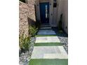 Modern walkway with stone pavers, green turf accents, and desert landscaping at 358 Solitude Peak Ln, Henderson, NV 89012