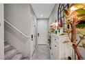 Bright foyer featuring a white console table, decorative plants, and tile flooring at 4160 Elegant Chateau St, Las Vegas, NV 89135
