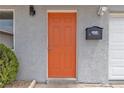 Close-up of the vibrant orange front door with modern hardware, black mailbox and newly textured paint at 4404 Hillcrest Ave, Las Vegas, NV 89102