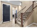 Inviting foyer features a staircase with carpeted steps and an elegant front door at 465 Cabral Peak St, Las Vegas, NV 89138