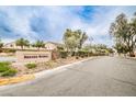 Street view of the community sign reading 'Nevada Ranch' with manicured landscaping at 4833 Straight Flush Dr # 103, Las Vegas, NV 89122