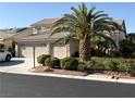 Charming home with a lush lawn and large palm tree at 5104 Burr Oak Dr, Las Vegas, NV 89130