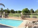 Inviting backyard pool area with lounge chairs and a view of the golf course at 5104 Burr Oak Dr, Las Vegas, NV 89130