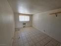 A simple empty bedroom with tile floor and window at 5440 Swenson St # 18, Las Vegas, NV 89119
