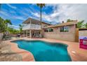 Enjoy this backyard oasis with a refreshing pool, balcony, and outdoor dining area ideal for relaxation at 601 Cragin Park Dr, Las Vegas, NV 89107