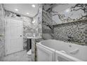 Luxurious bathroom features elegant marble tiling, a walk-in shower, and stylish fixtures at 601 Cragin Park Dr, Las Vegas, NV 89107