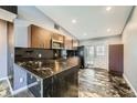 Modern kitchen with granite countertops, stainless steel appliances, and updated cabinets at 601 Ordrich Pl, Las Vegas, NV 89145
