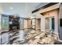 Stylish living room with sleek fireplace, modern sliding doors, and unique flooring at 601 Ordrich Pl, Las Vegas, NV 89145
