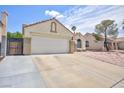 Home featuring a spacious two-car garage and well-kept driveway, blending functionality with classic design at 610 Playa Del Sol Way, Henderson, NV 89015