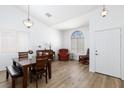 Bright living room with vaulted ceilings, hardwood floors, and a large window for natural light at 610 Playa Del Sol Way, Henderson, NV 89015