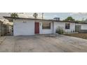 Charming single-story home featuring a minimalist front yard, unique front door, and a gated entrance at 613 Stanford St, Las Vegas, NV 89107
