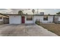 Charming single-story home featuring a minimalist front yard, unique front door, and a gated entrance at 613 Stanford St, Las Vegas, NV 89107