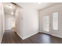 Inviting entryway with laminate flooring, a decorative glass front door, and ample natural light at 6140 Passionate Ct, North Las Vegas, NV 89031