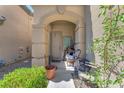 Inviting front porch featuring decorative accents and potted plants, leading to the home's entrance at 6247 Sugartree Ave, Las Vegas, NV 89141