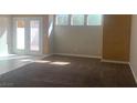 Bright living room featuring high ceilings, large windows, and neutral paint at 6412 Starling Mesa St, North Las Vegas, NV 89086
