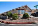 Charming one-story home featuring desert landscaping and a brick-lined flower bed at 6520 Blooming Sun Ct, Las Vegas, NV 89142