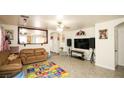 Inviting living room with tiled floors and a decorative mirror reflecting the kitchen at 6520 Blooming Sun Ct, Las Vegas, NV 89142