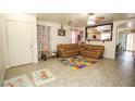 Bright living room with neutral walls, tiled floors and a view leading to the kitchen at 6520 Blooming Sun Ct, Las Vegas, NV 89142