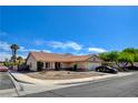 Attractive single-story house with a red tile roof, desert landscaping, and an attached two-car garage at 7417 Radville Dr, Las Vegas, NV 89129