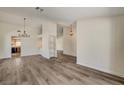 Bright living room featuring modern gray wood flooring and stylish light fixtures at 7417 Radville Dr, Las Vegas, NV 89129