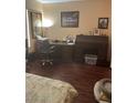 Bedroom featuring a vintage desk, laminate flooring, and neutral wall color at 7850 Flagler St, Las Vegas, NV 89139