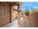 Covered entrance with stone pillars and a walkway leading to a gated courtyard at 7937 Granite Walk Ave, Las Vegas, NV 89178