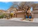 Two-story home with desert landscaping and a two-car garage in a quiet neighborhood at 7937 Granite Walk Ave, Las Vegas, NV 89178