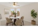 Cozy dining area featuring a modern table, stylish chairs, and natural light from large windows at 8934 Pomona Ct, Las Vegas, NV 89147