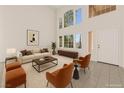Bright living room with soaring ceilings, large windows, and contemporary furnishings, perfect for entertaining at 8934 Pomona Ct, Las Vegas, NV 89147