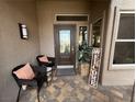 Cozy front porch features seating, decor, and patterned pavers at 10013 Hunter Springs Dr, Las Vegas, NV 89134