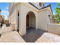 Inviting front entrance with an arched doorway and landscaped surroundings at 10829 Crestview Pointe Ave, Las Vegas, NV 89166
