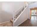 Modern staircase with sleek railings and wood flooring leading to the upper level at 10829 Crestview Pointe Ave, Las Vegas, NV 89166