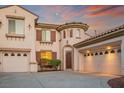 Charming two-story home with terracotta roof, three-car garage and well-maintained landscaping at 11569 Velicata Ct, Las Vegas, NV 89138