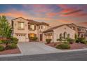 Charming two-story home with terracotta roof, three-car garage and beautiful sunset at 11569 Velicata Ct, Las Vegas, NV 89138