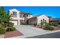 Charming two-story home with terracotta roof, three-car garage and well-maintained landscaping at 11569 Velicata Ct, Las Vegas, NV 89138