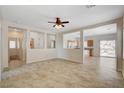 Bright living room features neutral walls, tile flooring, and open-concept design at 177 Shaded Peak St, Henderson, NV 89012