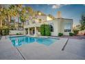 A luxurious pool with a sunning deck is showcased in this private backyard oasis with landscaping at 2104 Inverness Dr, Henderson, NV 89074