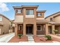 Inviting two-story home with a covered porch and well-manicured front yard at 2199 Timescape Ct, Las Vegas, NV 89123