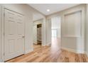 Inviting entryway with wood-look flooring, a coat closet, and an open view to the living area at 2445 Sturrock Dr, Henderson, NV 89044