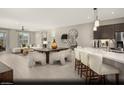 Bright, open-concept design with dining area, living room, and kitchen featuring modern finishes and stylish furnishings at 2607 Regency Cove Ct # Lot 11, Las Vegas, NV 89121