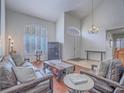 Inviting living room with a vaulted ceiling, plantation shutters, and comfortable seating, offering a cozy atmosphere at 2732 Dune Cove Rd, Las Vegas, NV 89117